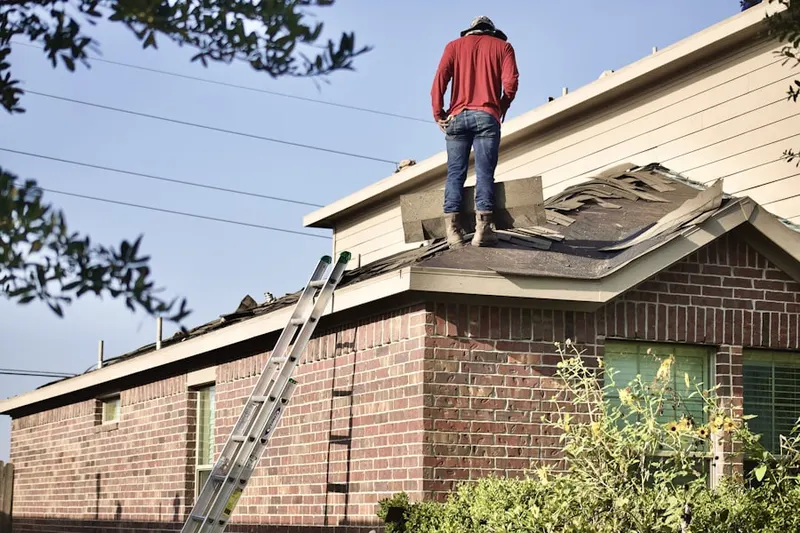 Professional roofer working on a residential roof in Rebersburg